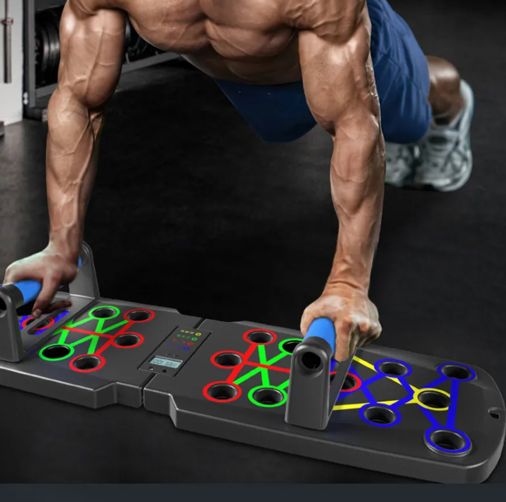 Planche de pompes Power Flex grise, anneaux rouges, verts, bleus et poignées en mousse.