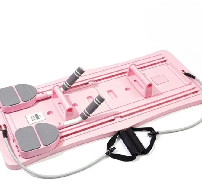 Planche Pilates coulissante compacte rose avec coussins et élastiques gris